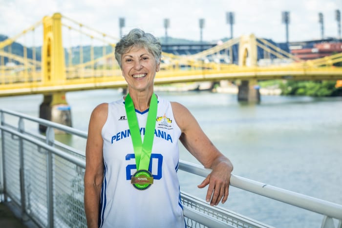 Basketball player Paula Franetti, 67, receives her Humana Game Changer medal at the 2023 National Senior Games in Pittsburgh.